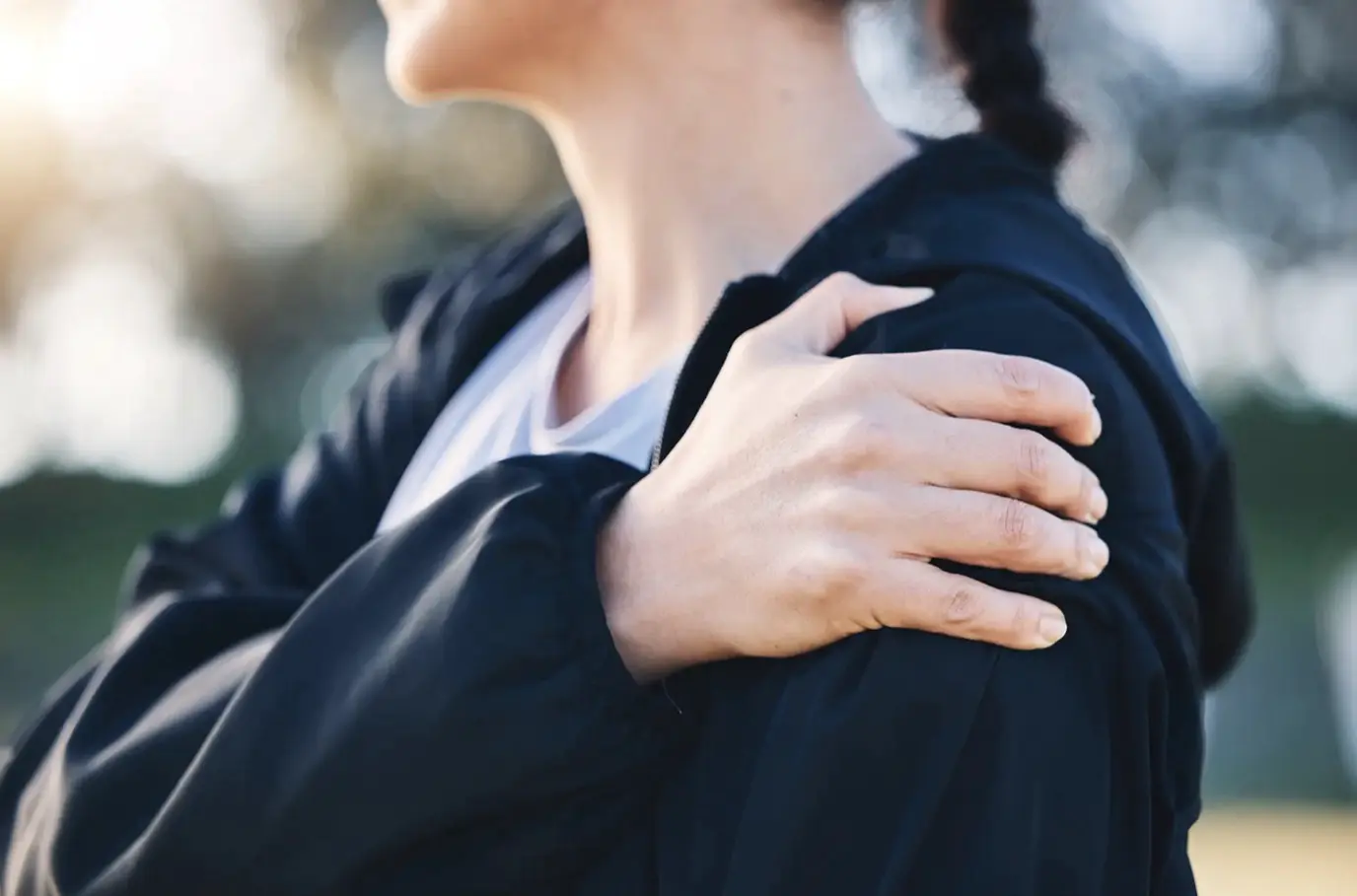 A woman holding her elbow after a fall wondering if it might be broken