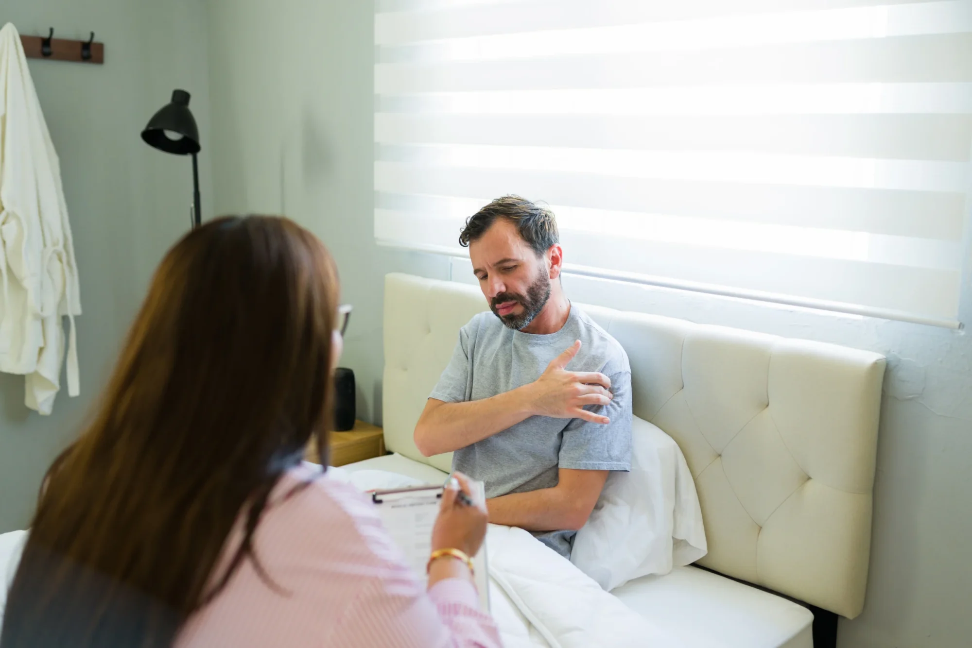 patient discussing shoulder revision surgery with his doctor.