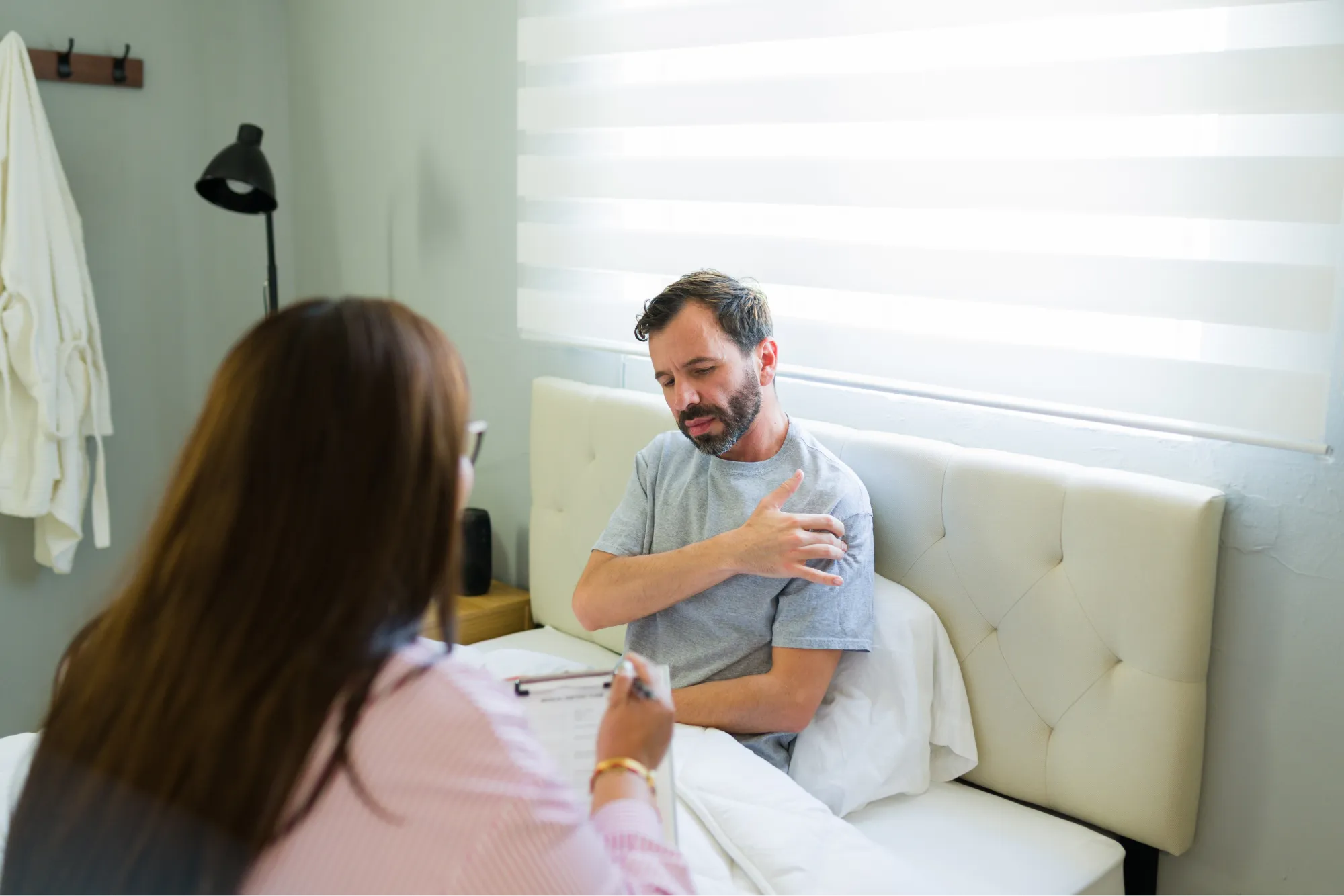 patient discussing shoulder revision surgery with his doctor.